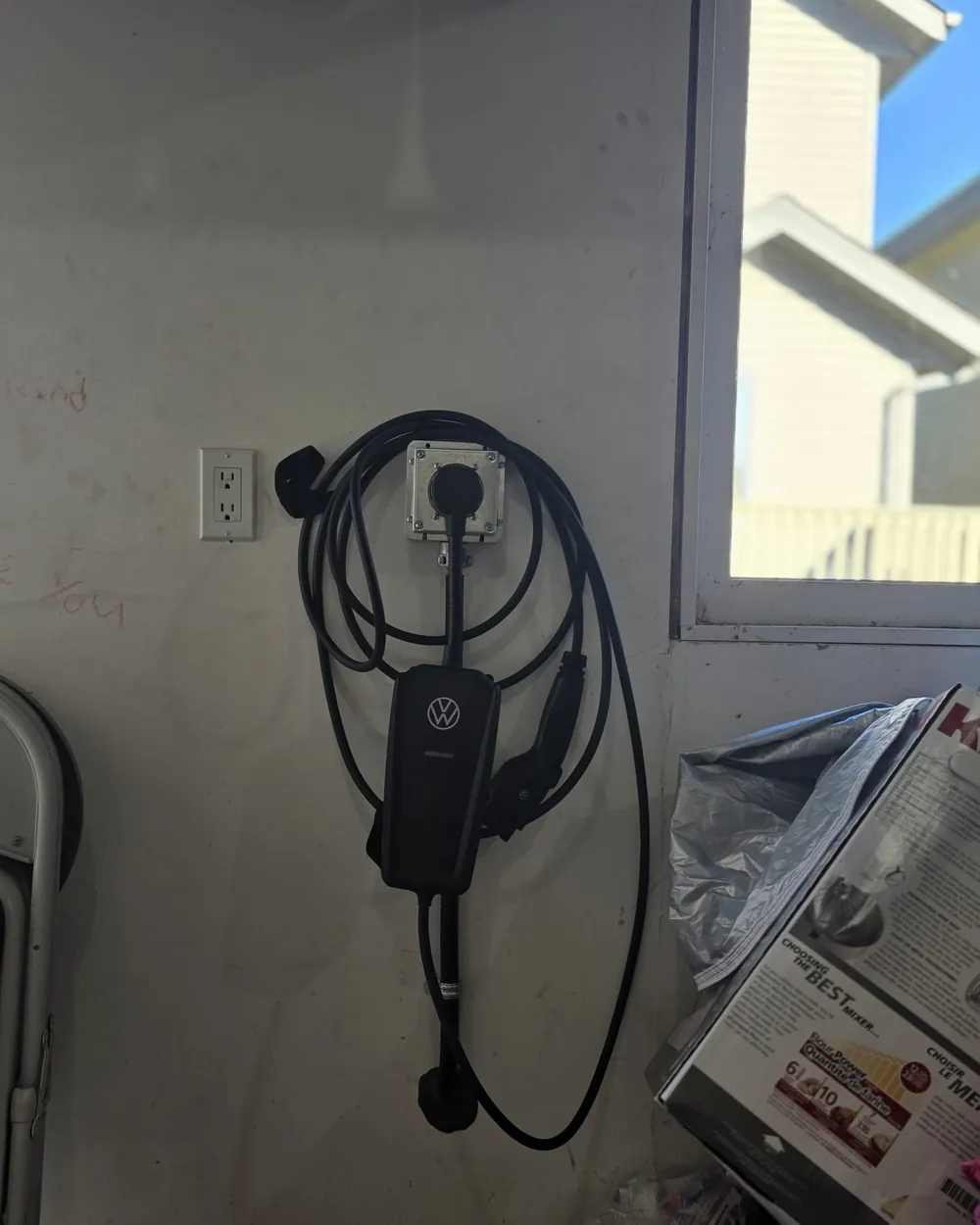 Volkswagen EV charging cable stowed on a garage wall after a Raydn EV charger install in Edmonton